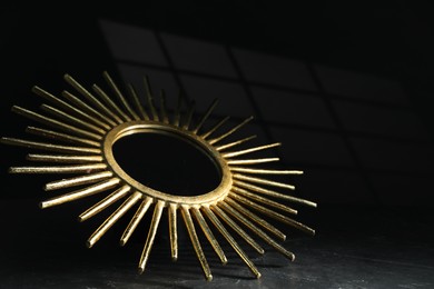 Photo of Stylish golden decor on black background, closeup