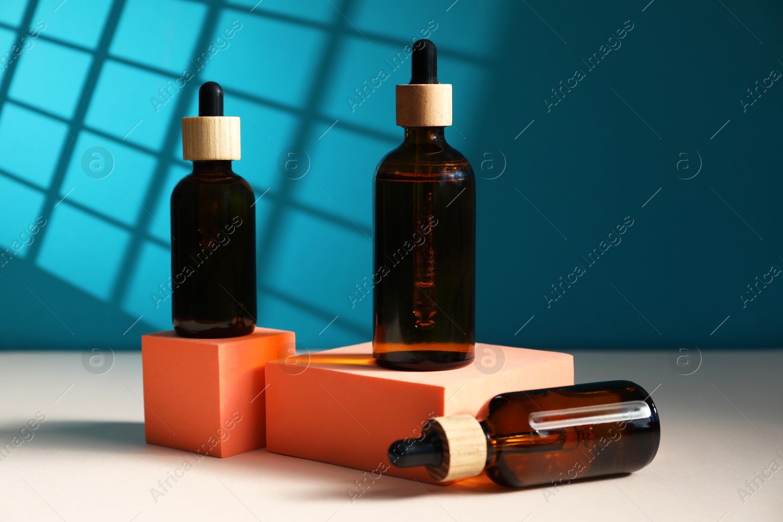 Photo of Bottles of cosmetic product on color background