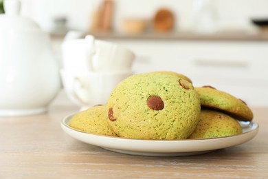 Photo of Delicious mint chocolate chip cookies on wooden table, closeup