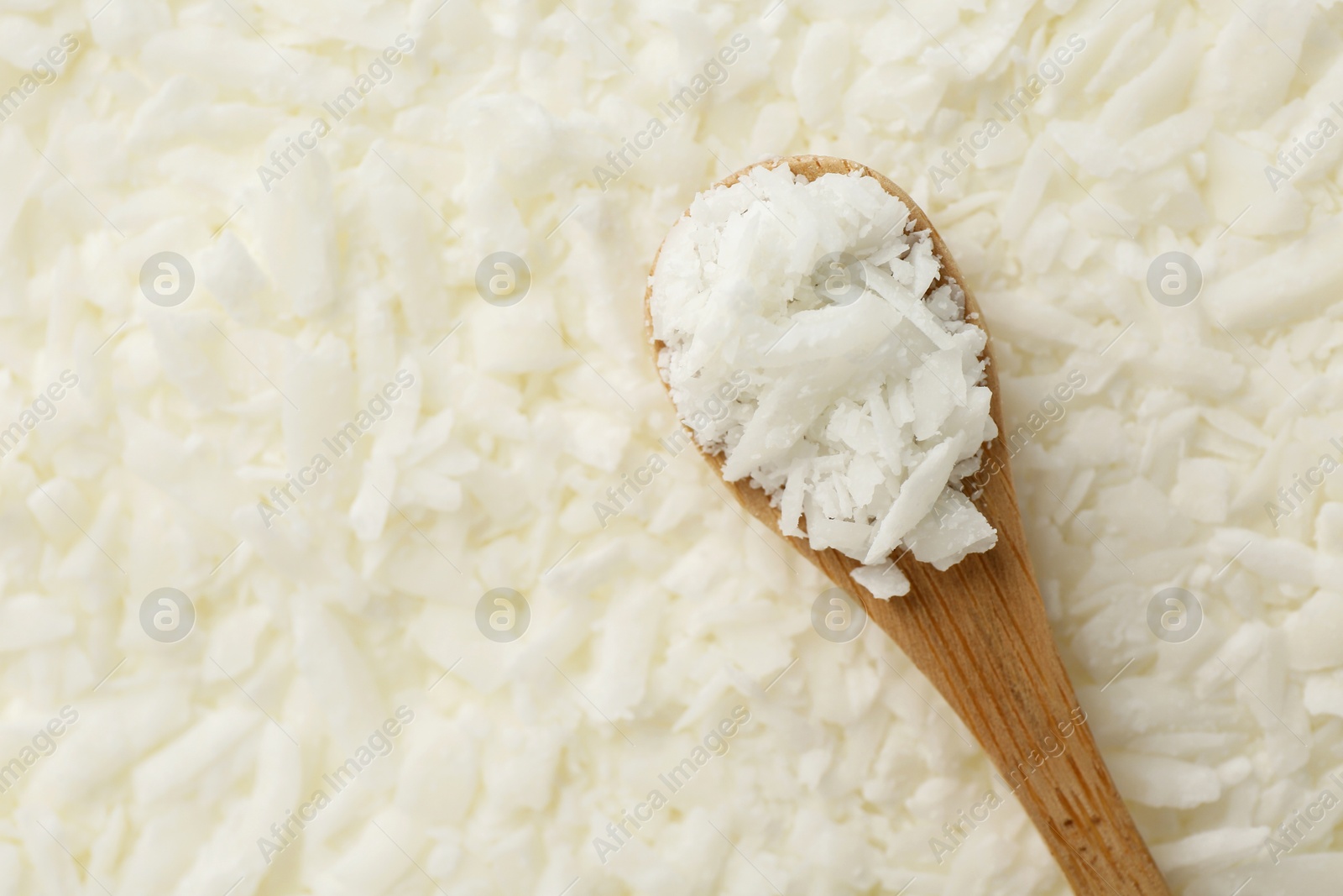 Photo of White soy wax flakes and spoon, top view