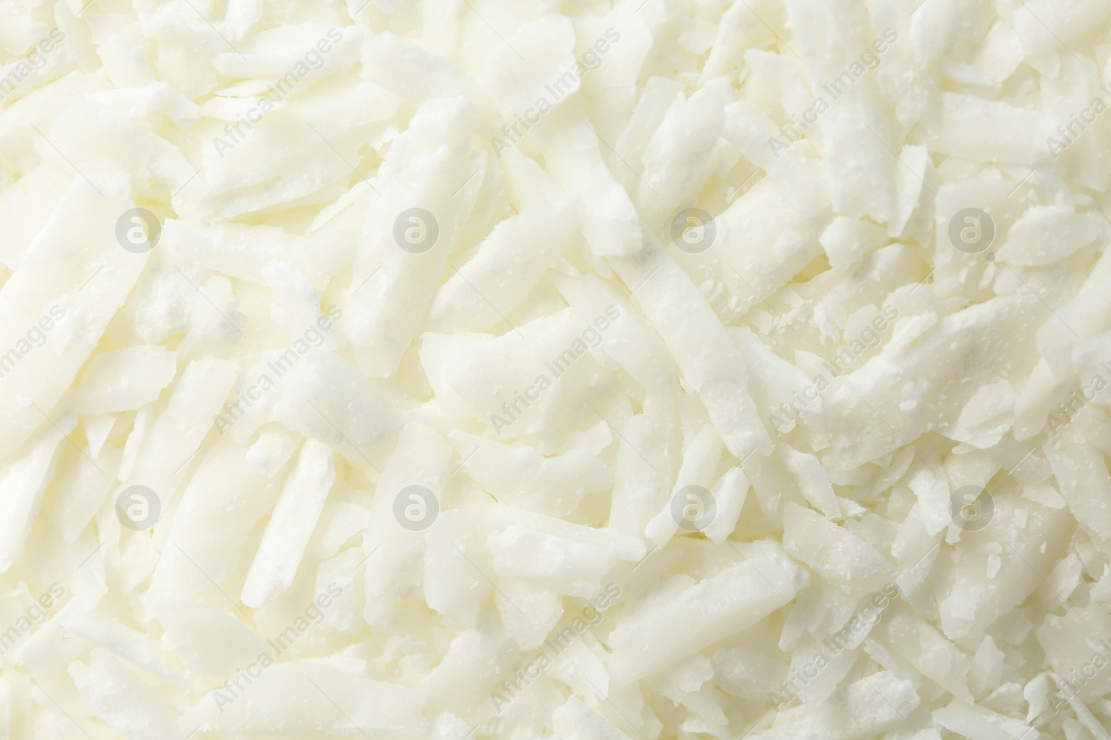 Photo of White soy wax flakes as background, closeup