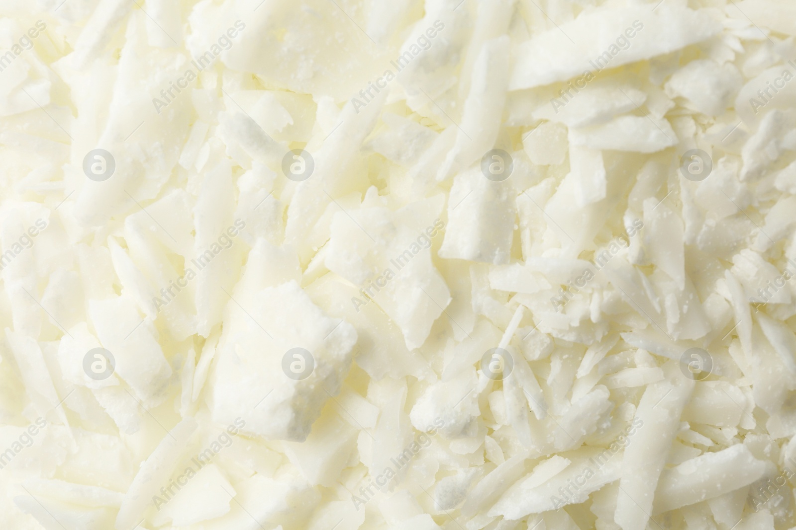 Photo of White soy wax flakes as background, closeup