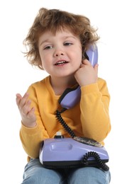 Photo of Cute little boy with telephone on white background