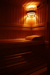 Photo of View of empty wooden sauna with bench