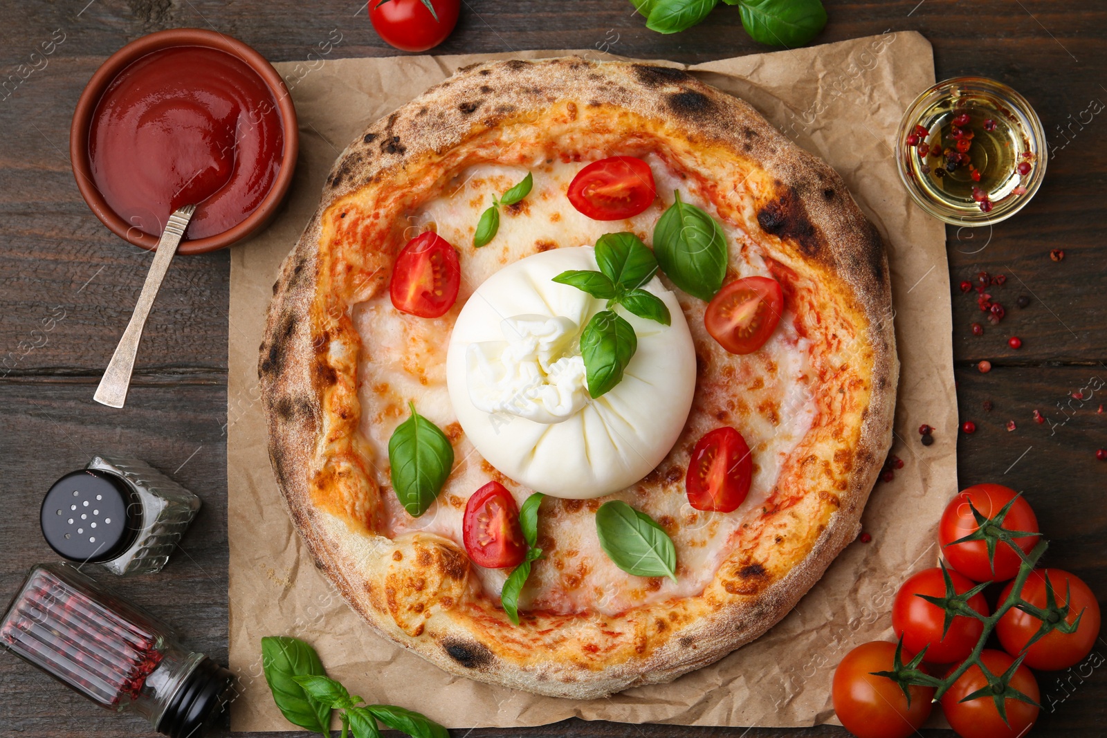 Photo of Delicious pizza with burrata cheese served on wooden table, top view