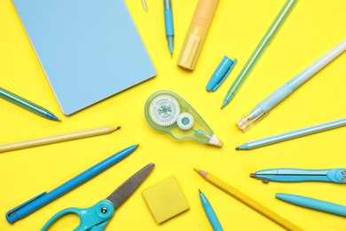 Photo of Different stationery on yellow background, flat lay