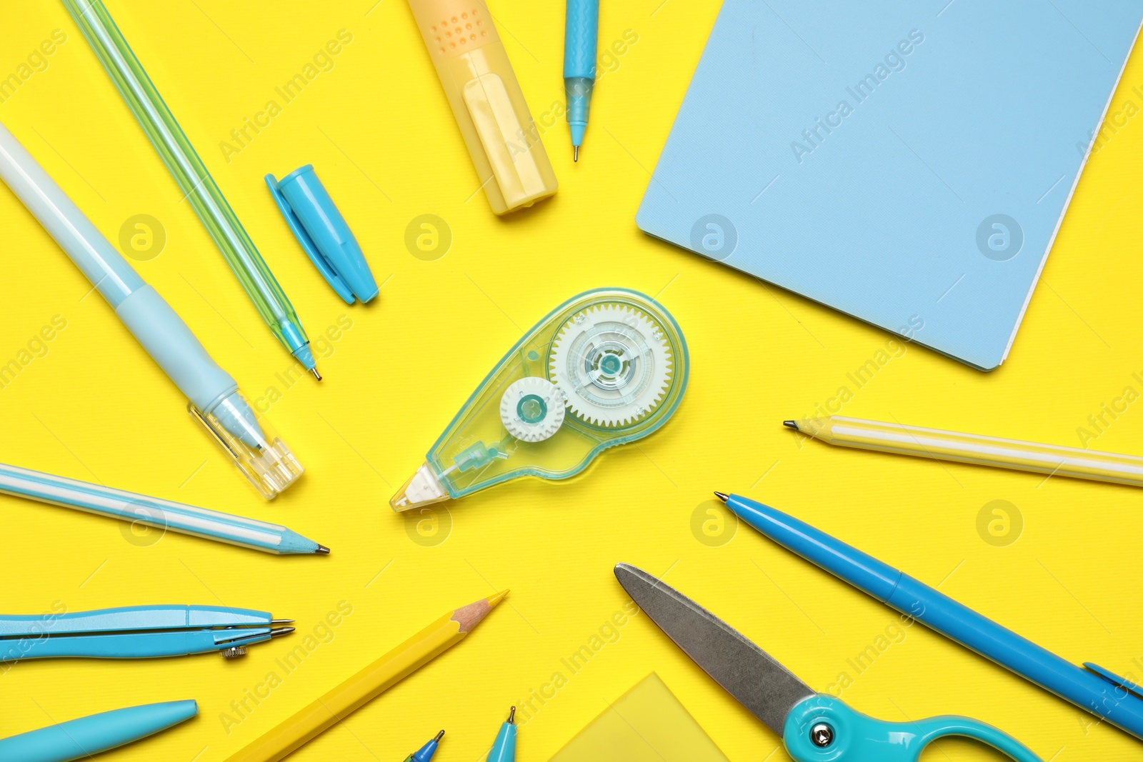 Different stationery on yellow background, flat lay Photo of Different stationery on yellow background, flat lay