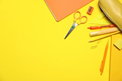 Photo of Different stationery on yellow background, flat lay. Space for text