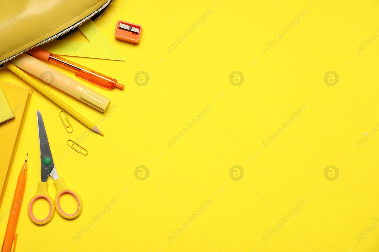 Different stationery on yellow background, flat lay. Space for text Photo of Different stationery on yellow background, flat lay. Space for text