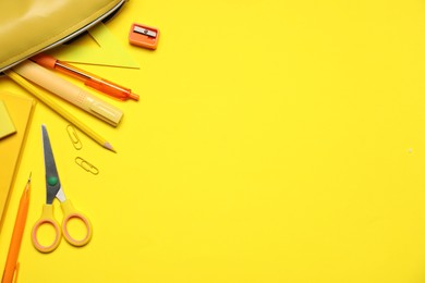 Photo of Different stationery on yellow background, flat lay. Space for text
