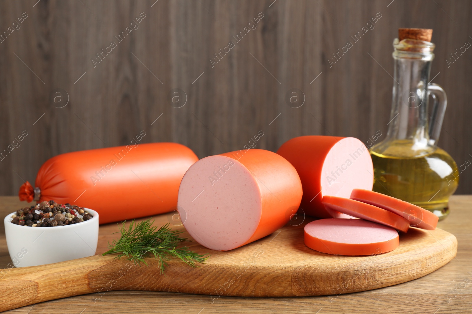 Photo of Tasty boiled sausages and spices on wooden table