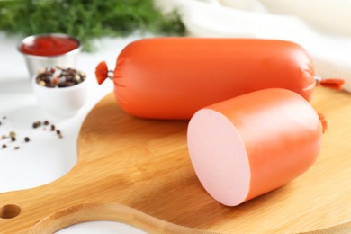 Photo of Tasty boiled sausages and spices on white table, closeup