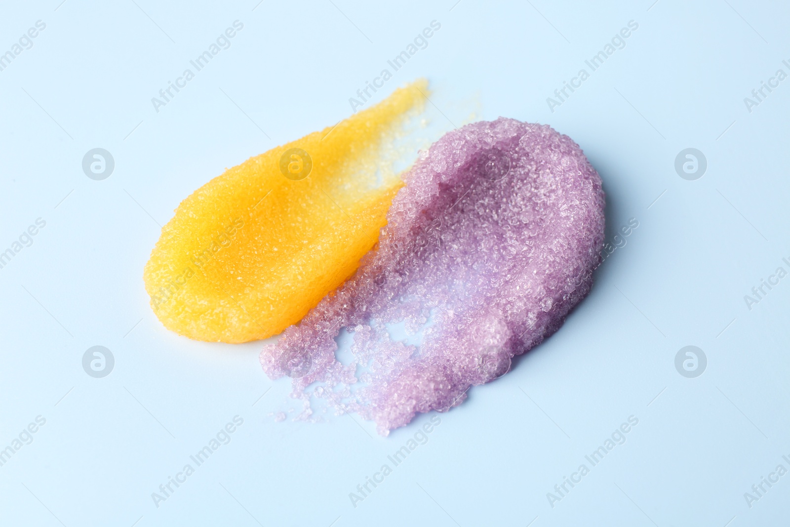 Photo of Smears of body scrubs on light background, closeup