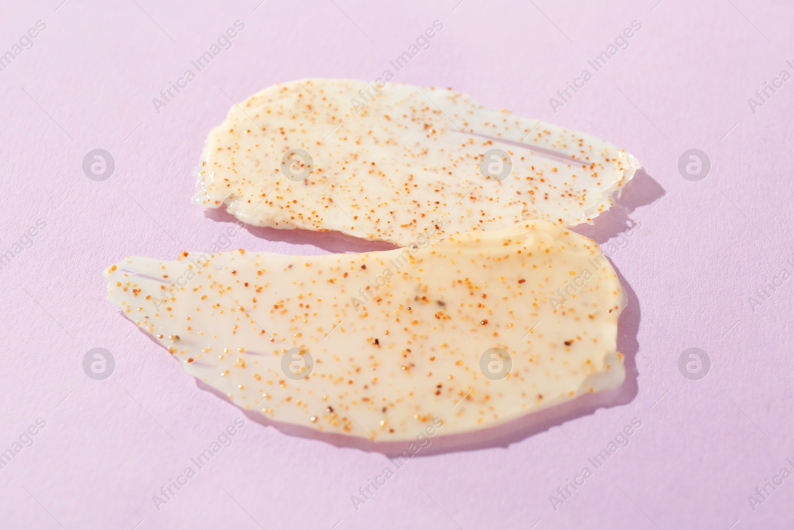 Photo of Samples of body scrubs on violet background. Skin care