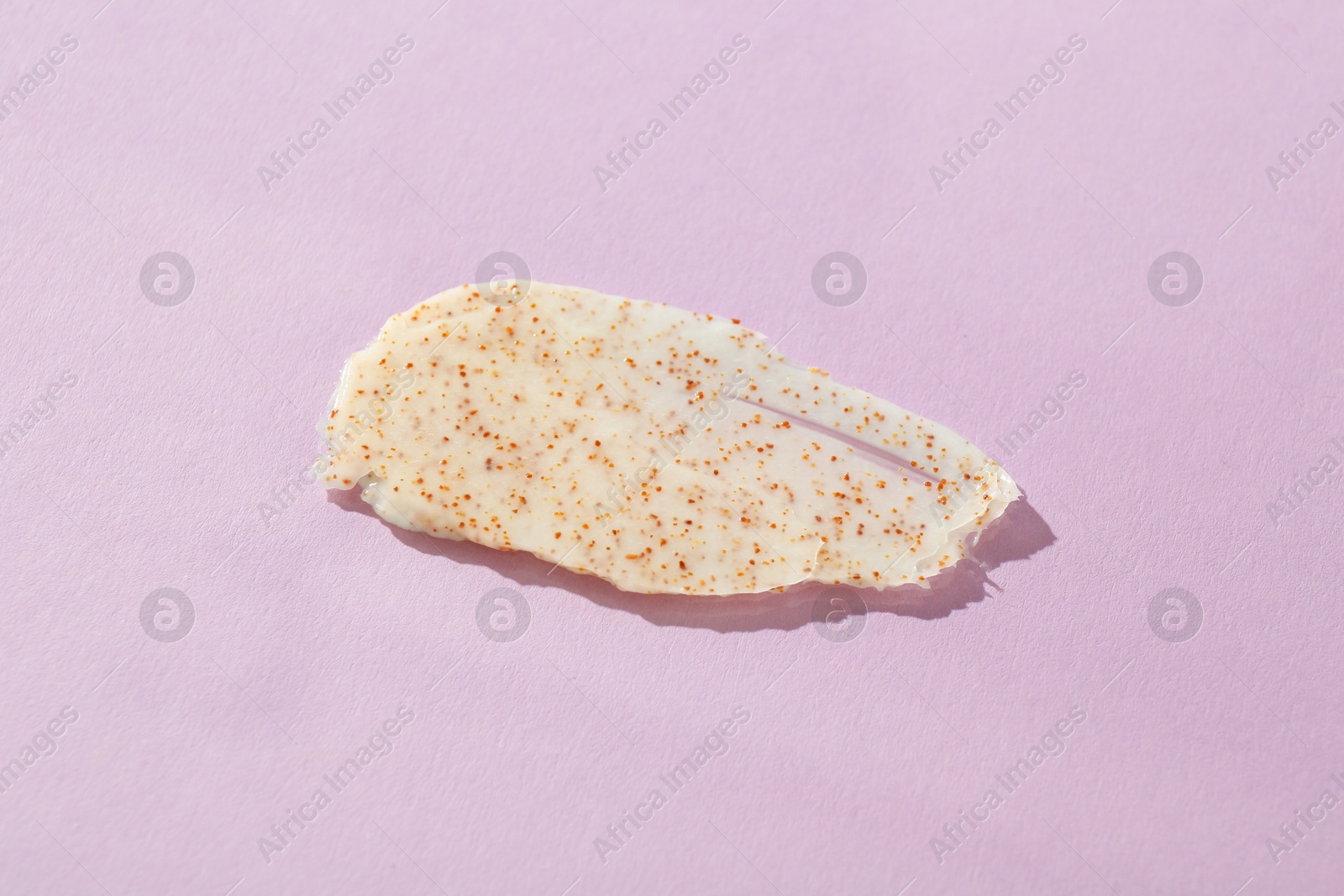 Photo of Sample of body scrub on violet background, top view. Skin care