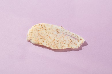 Photo of Sample of body scrub on violet background, top view. Skin care