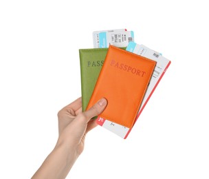 Photo of Woman holding passports with tickets on white background, closeup