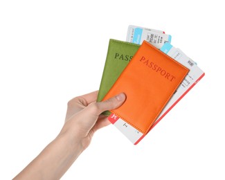 Photo of Woman holding passports with tickets on white background, closeup