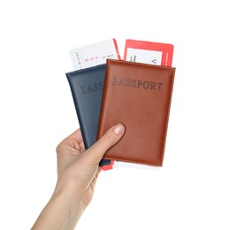 Photo of Woman holding passports with tickets on white background, closeup