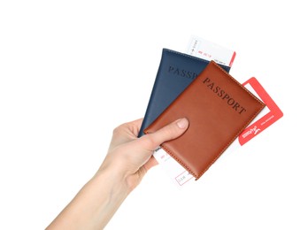 Photo of Woman holding passports with tickets on white background, closeup