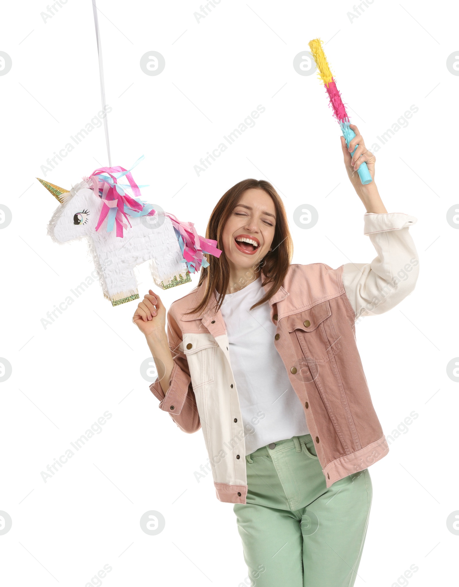 Photo of Happy woman with unicorn shaped pinata and stick isolated on white