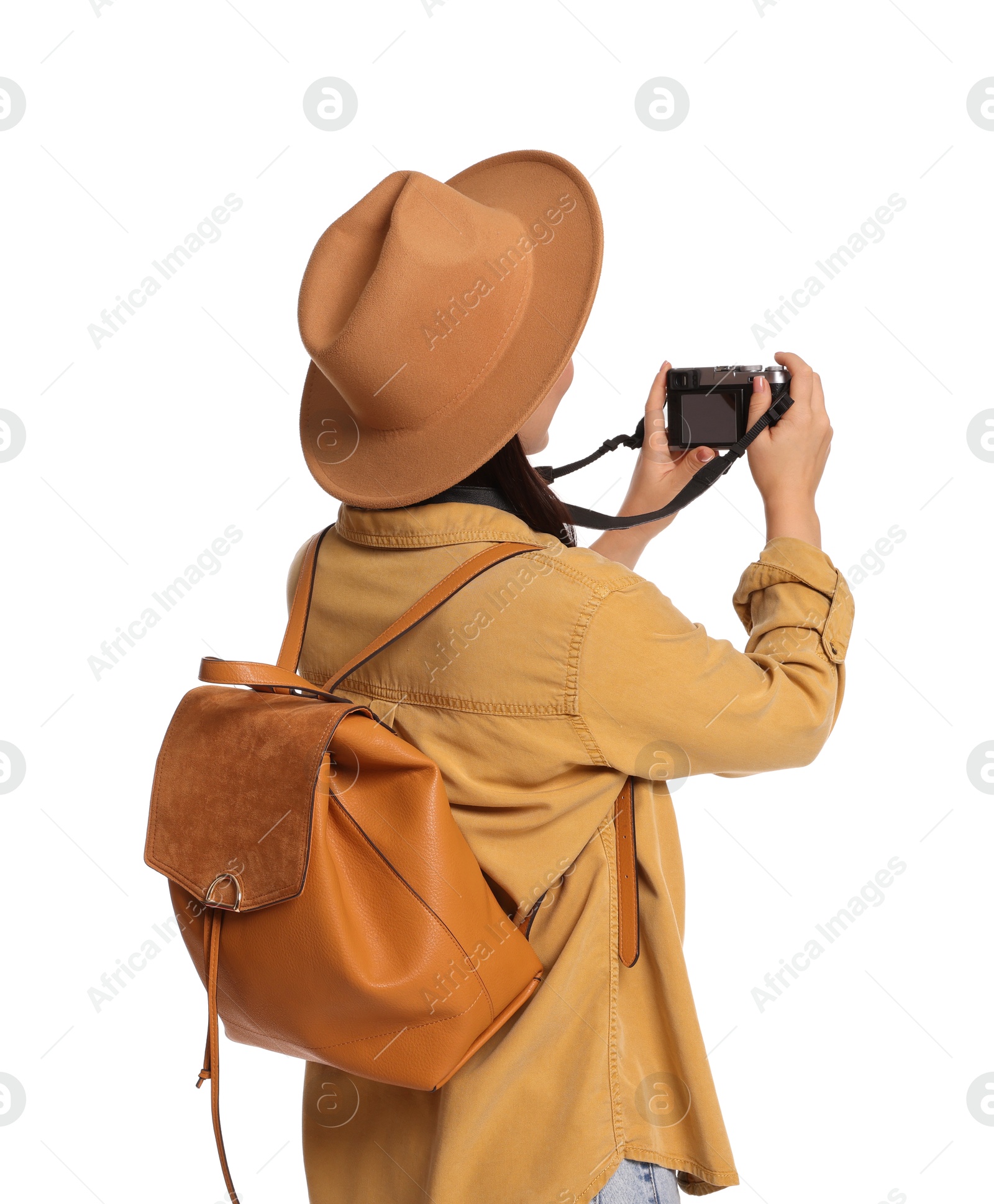 Photo of Traveller with backpack taking photo on white background, back view