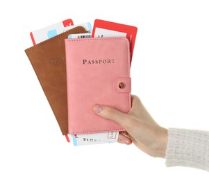 Photo of Woman holding passports with tickets on white background, closeup