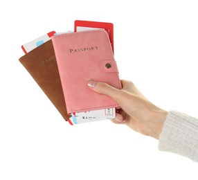 Photo of Woman holding passports with tickets on white background, closeup