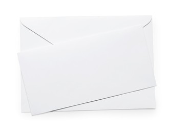 Photo of Envelope with card isolated on white, top view. Mockup for design