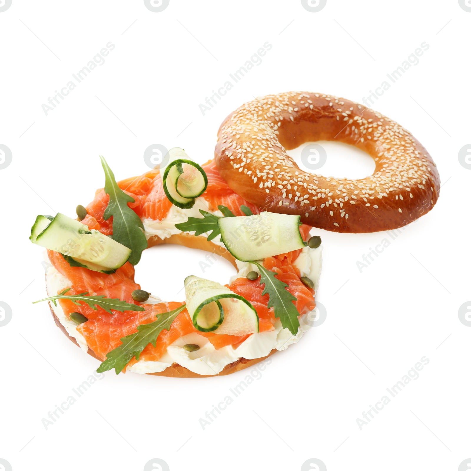 Photo of Delicious bagel with salmon, cream cheese and cucumber isolated on white