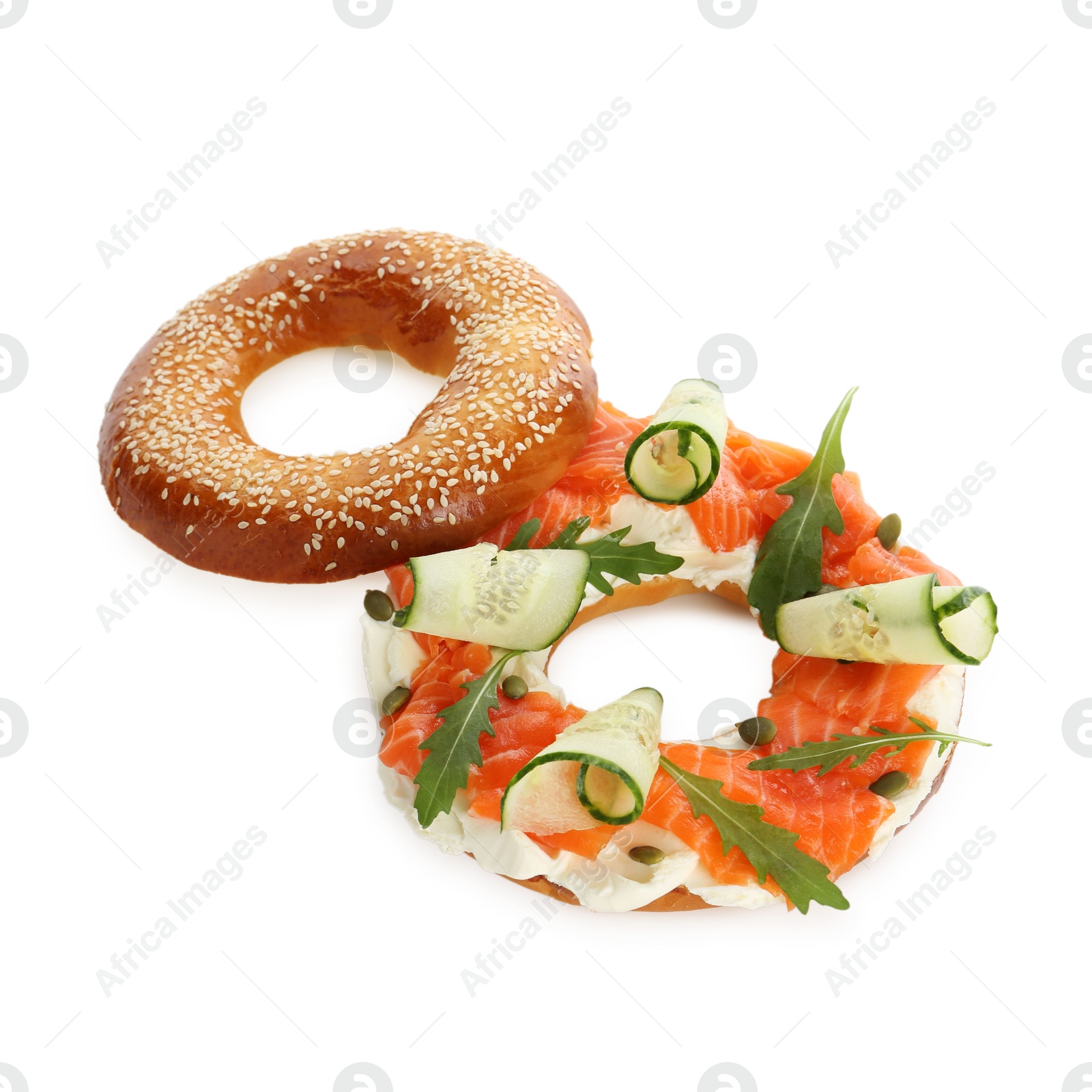 Photo of Delicious bagel with salmon, cream cheese and cucumber isolated on white