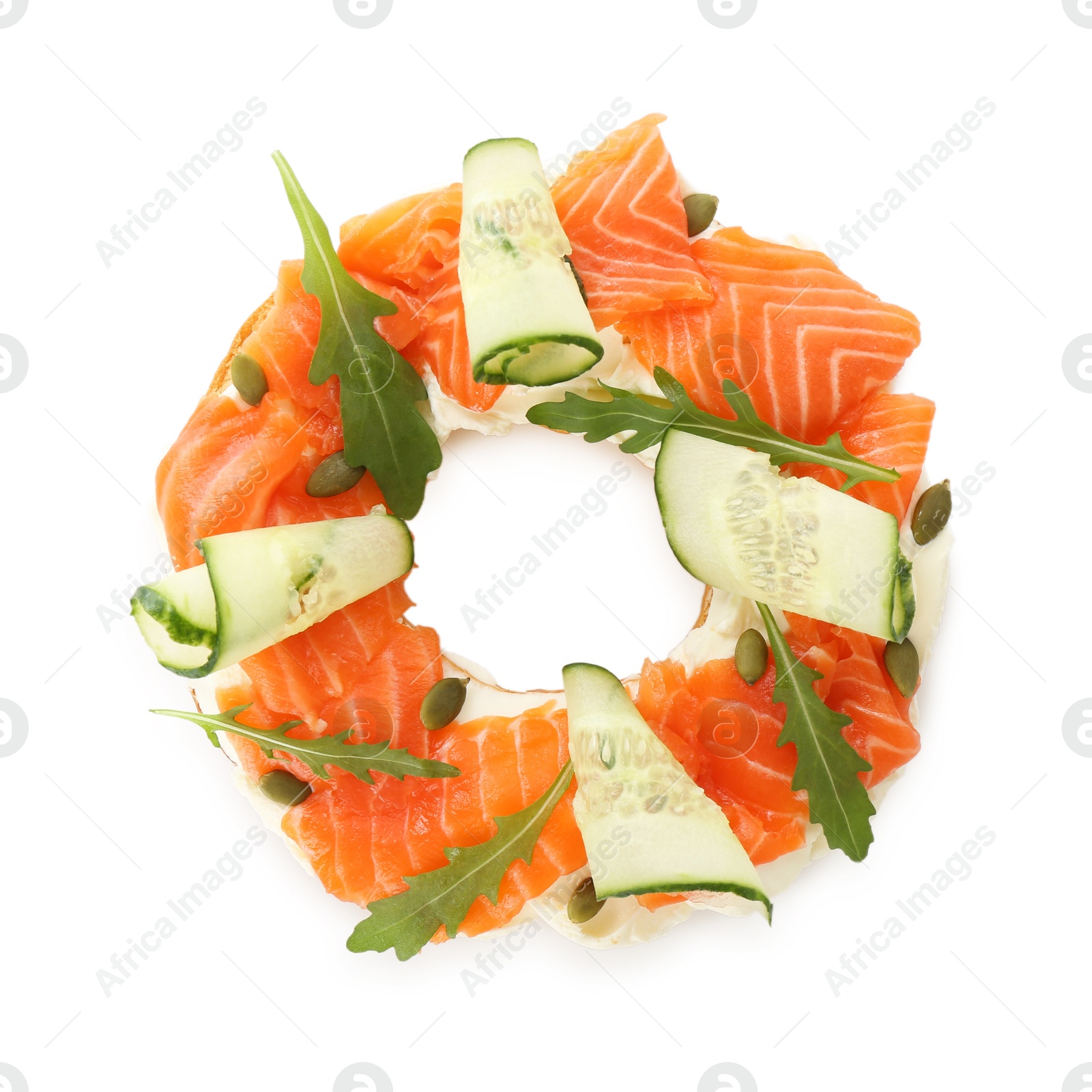 Photo of Half of delicious bagel with salmon, cream cheese and cucumber isolated on white, top view