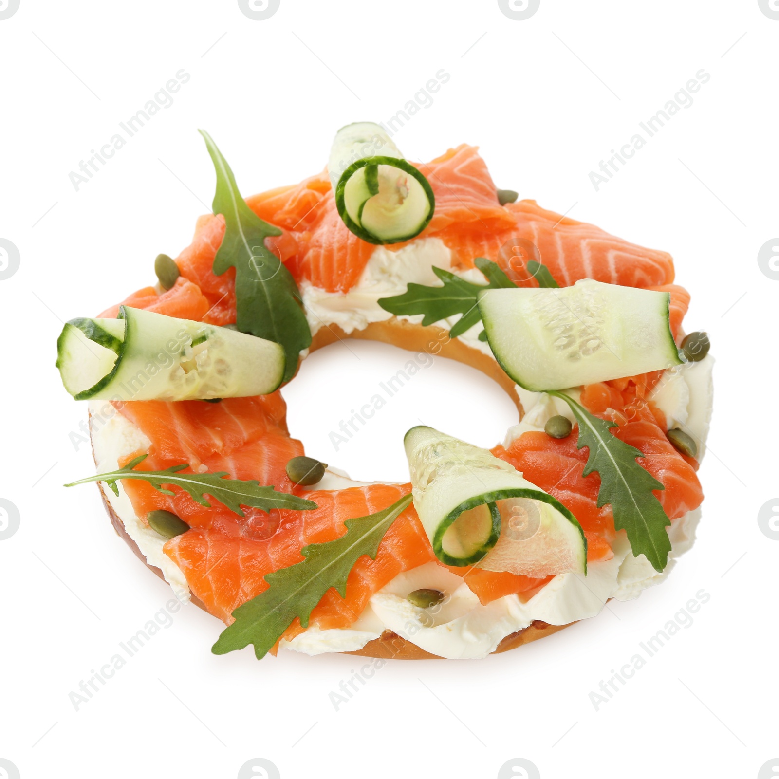 Photo of Half of delicious bagel with salmon, cream cheese and cucumber isolated on white