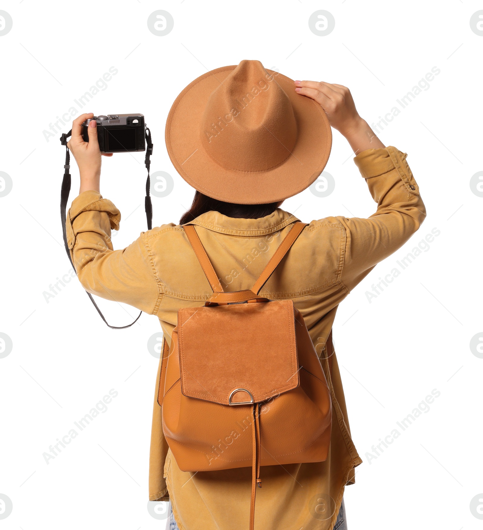 Photo of Traveller with backpack taking photo on white background, back view