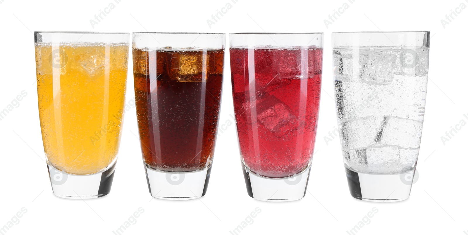 Photo of Soda water of different flavors with ice cubes in glasses isolated on white