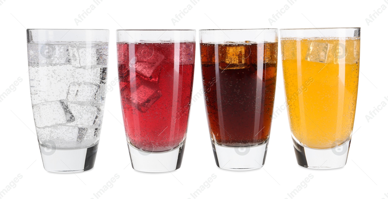 Photo of Soda water of different flavors with ice cubes in glasses isolated on white