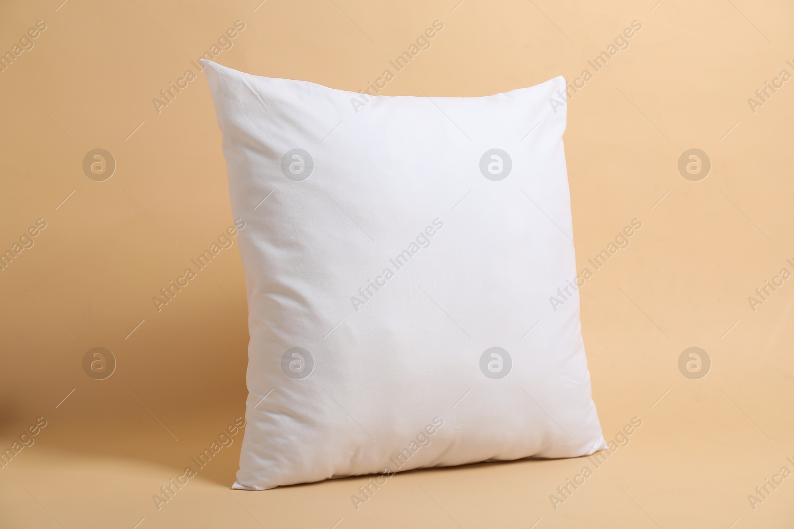 Photo of Blank white pillow for branding on beige background. Mockup for design