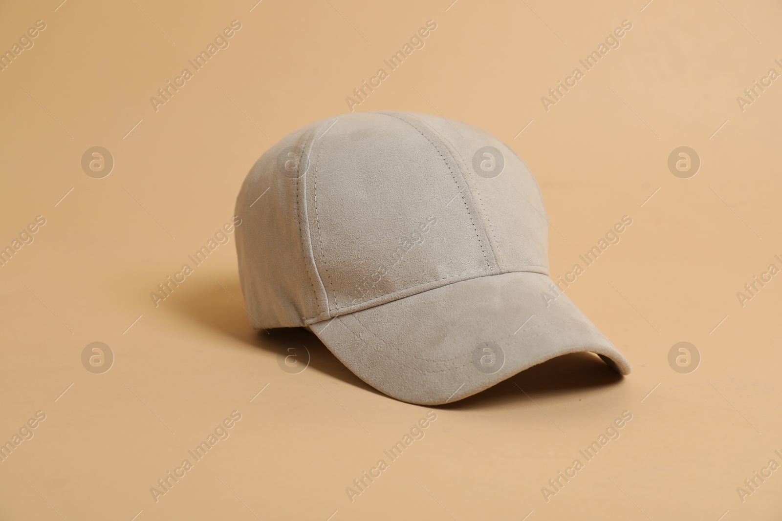 Photo of Blank baseball cap for branding on beige background. Mockup for design