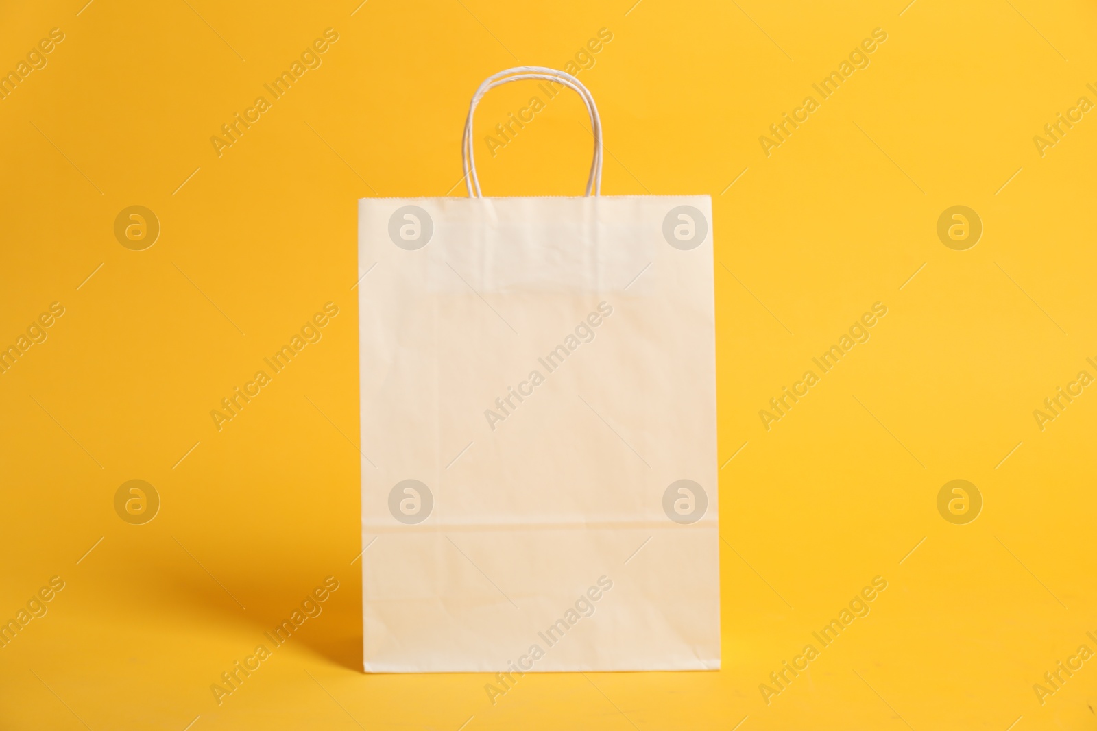 Photo of Blank shopping bag for branding on orange background. Mockup for design