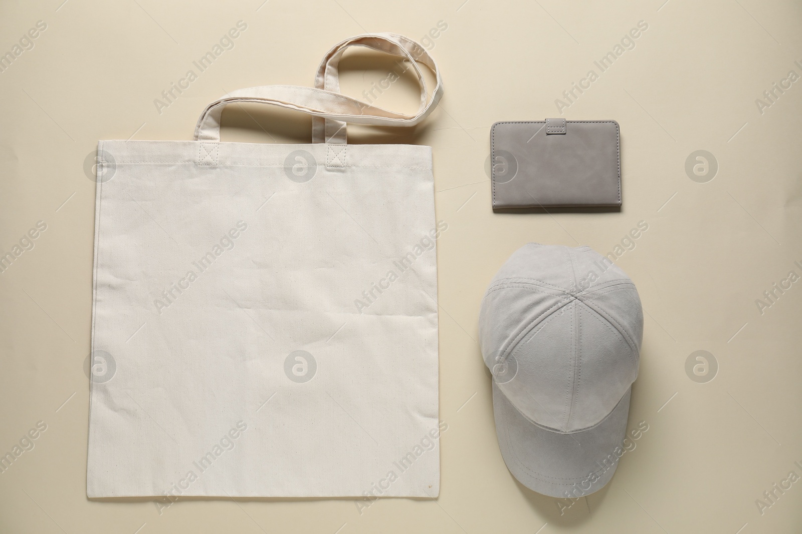 Photo of Different blank items for branding on beige background, flat lay. Mockup for design