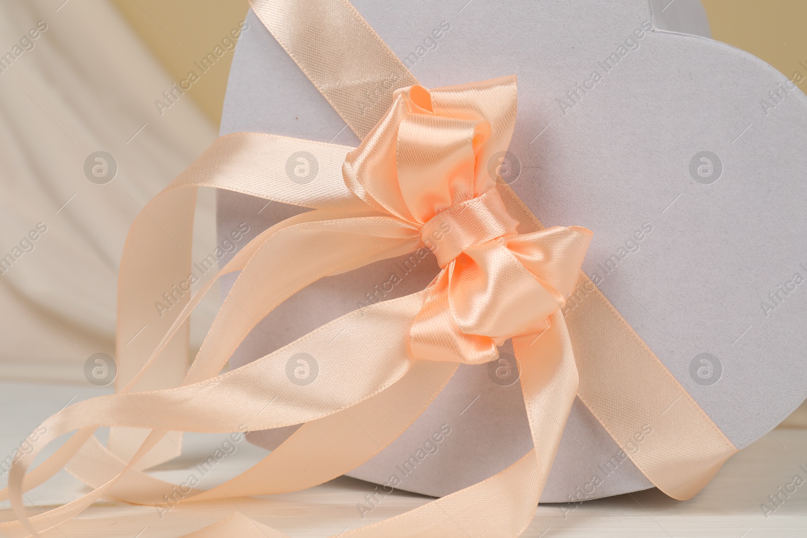 Photo of Beautiful wedding gift on white table, closeup