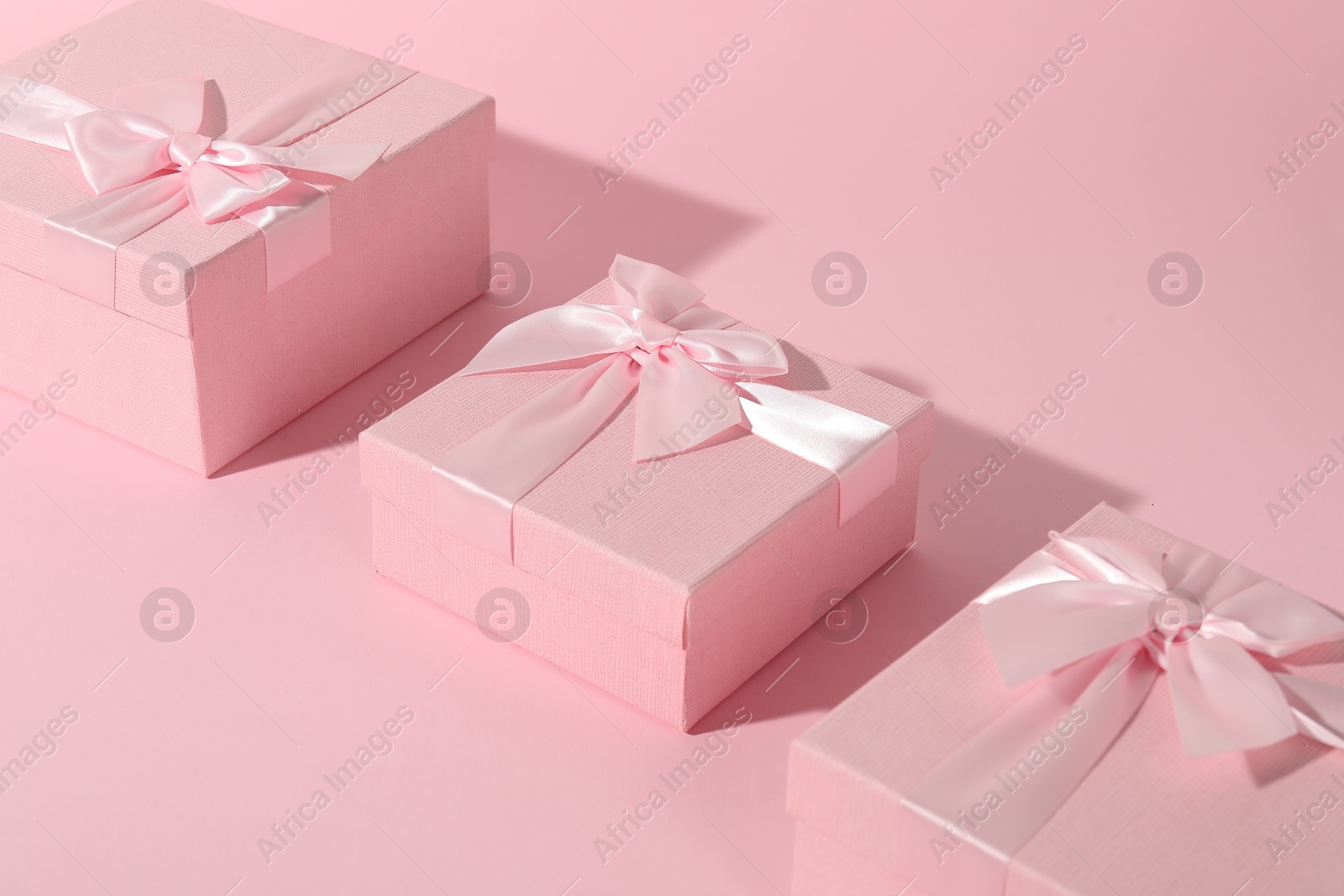 Photo of Three beautiful wedding gifts on pink background