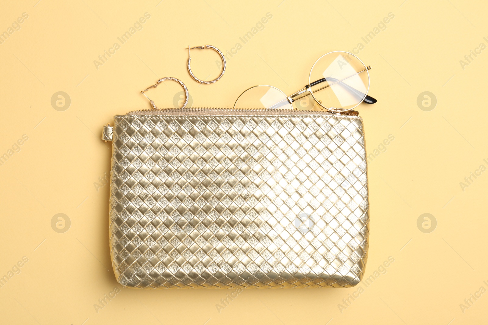 Photo of Beautiful bag and stylish accessories on beige background, flat lay