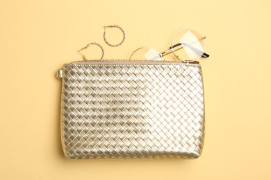 Photo of Beautiful bag and stylish accessories on beige background, flat lay