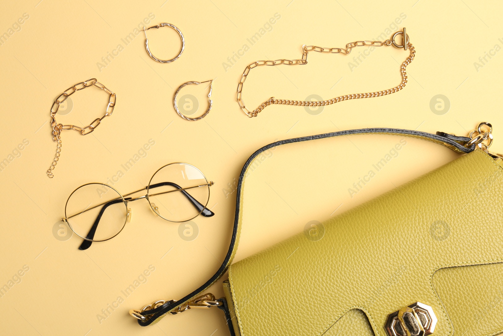 Photo of Beautiful bag and stylish accessories on beige background, flat lay