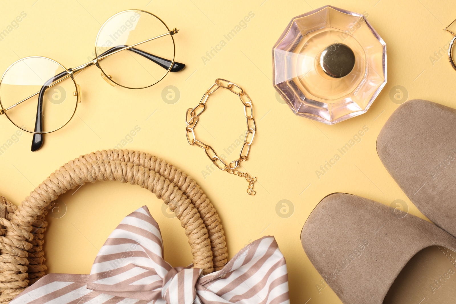 Photo of Bag, shoes and stylish accessories on beige background, flat lay