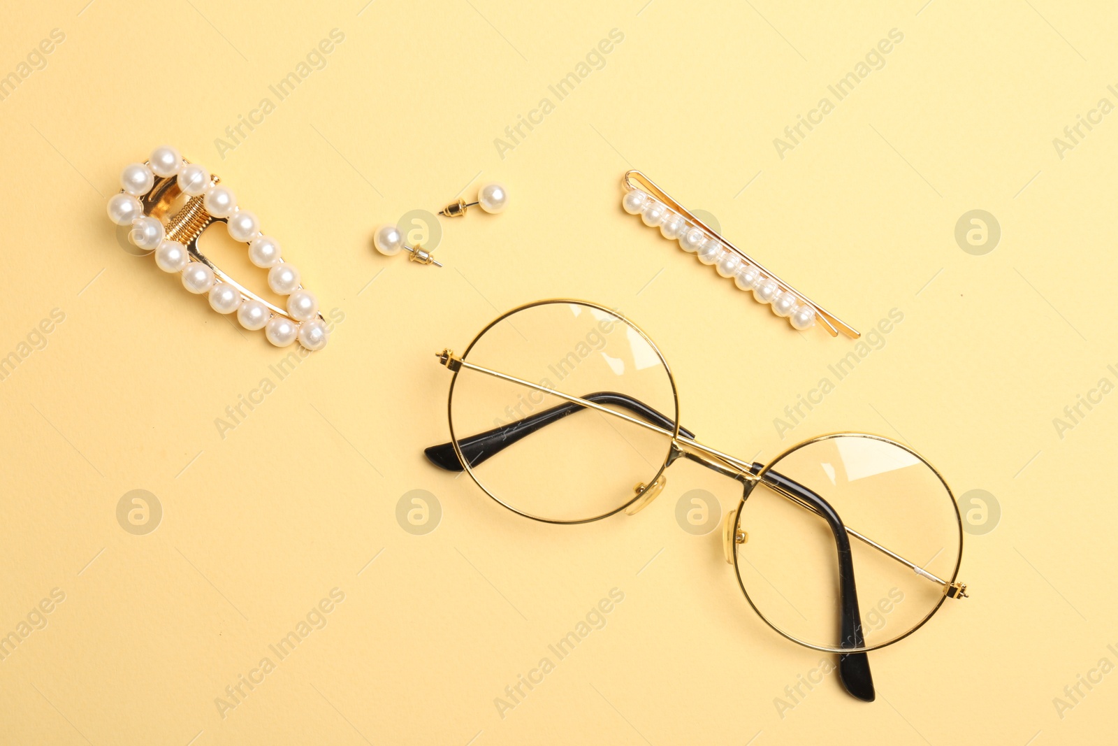 Photo of Stylish accessories on beige background, flat lay