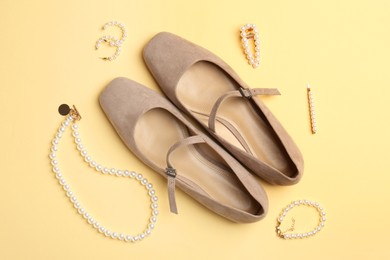 Photo of Shoes and stylish accessories on beige background, flat lay