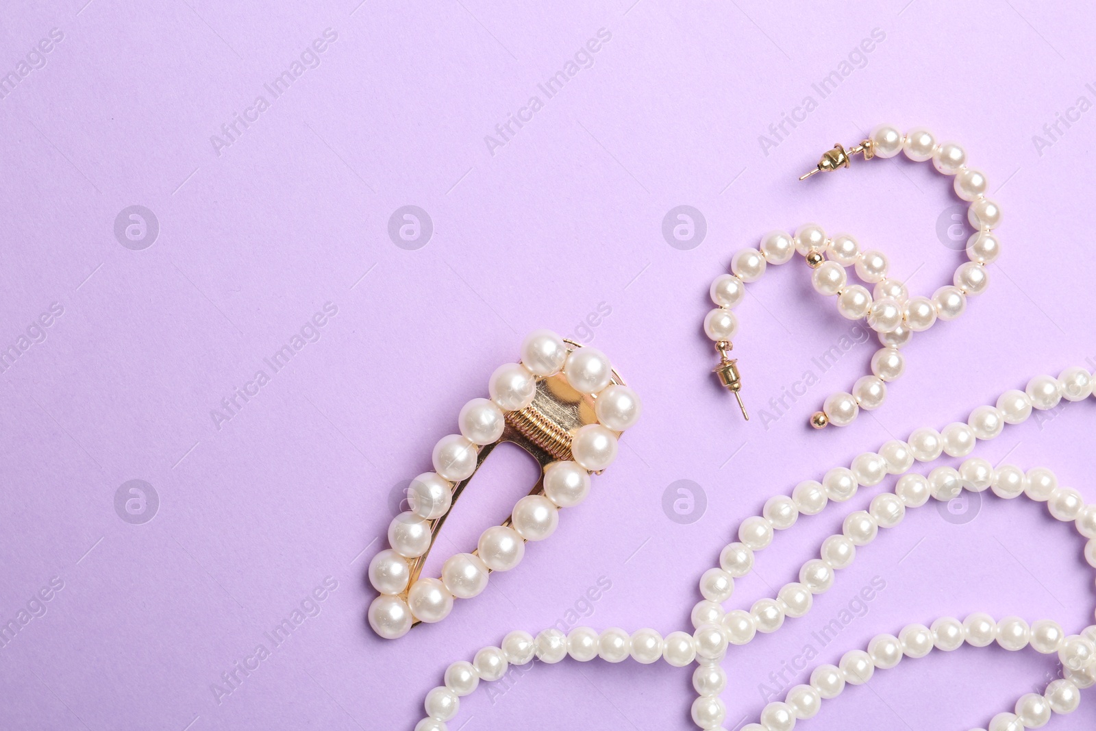 Photo of Stylish accessories on lilac background, flat lay. Space for text