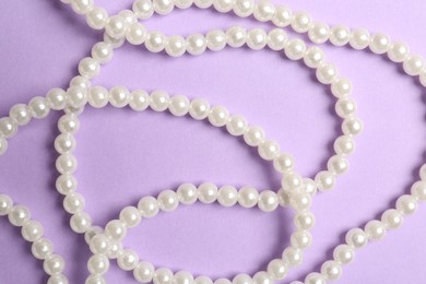 Photo of Stylish accessories on lilac background, flat lay